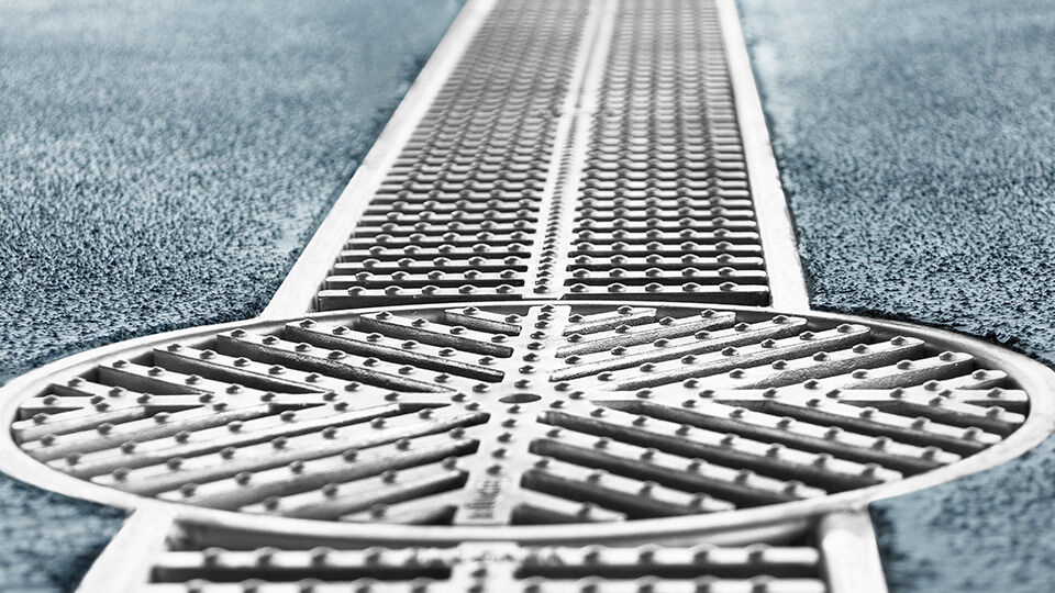 Zoomed in top view of a drain on a road